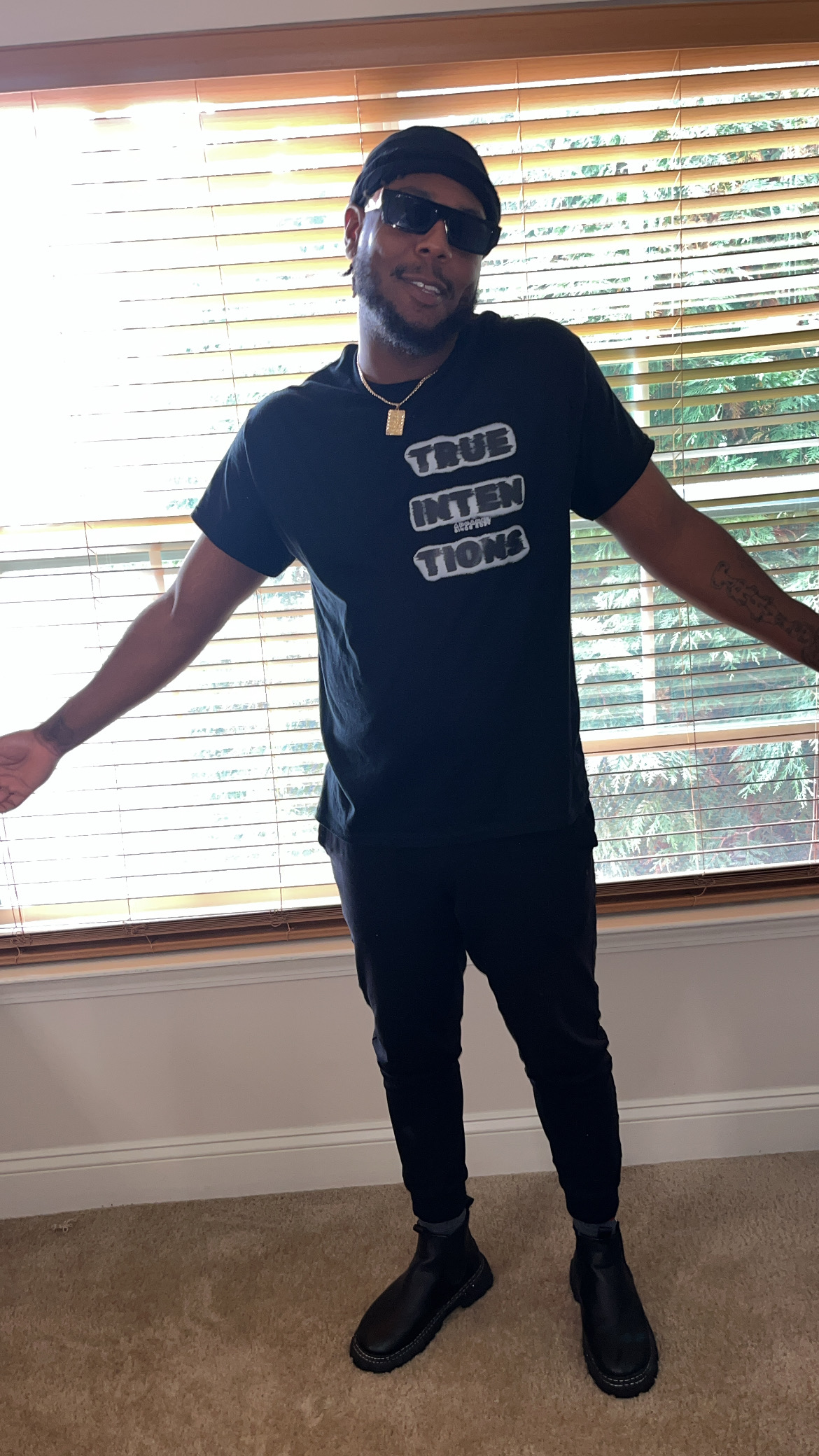 True Intentions creator modeling a finished black graphic shirt